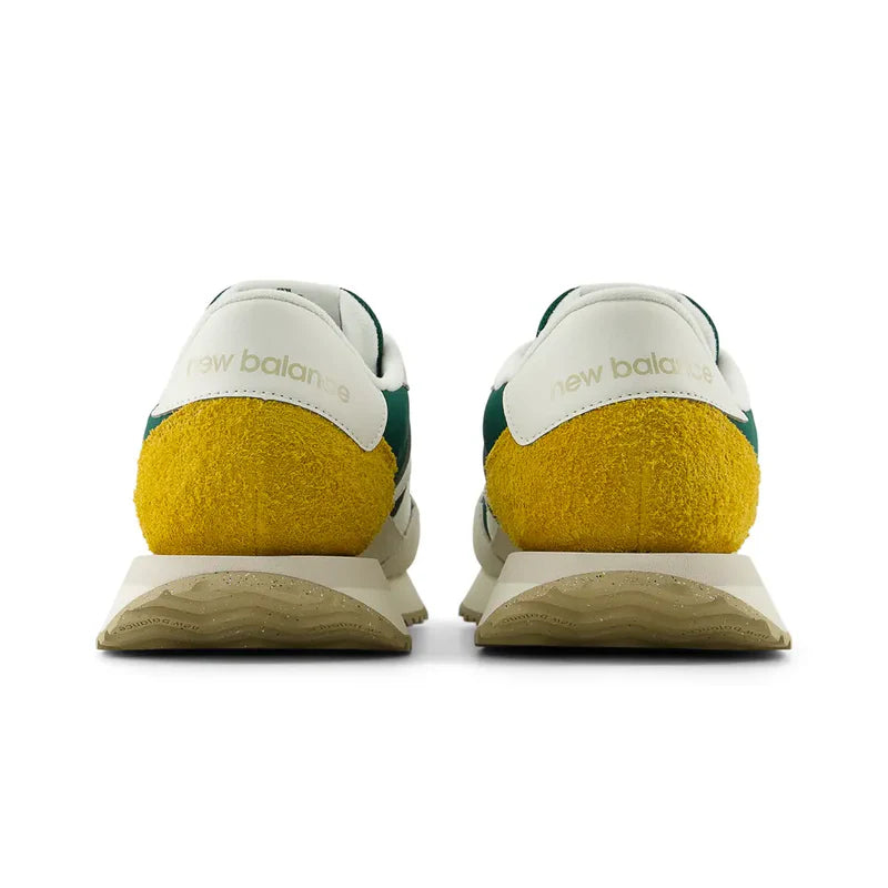 New Balance 237 V1 sneakers back view featuring white leather panels, yellow suede heel detail, and green accents.