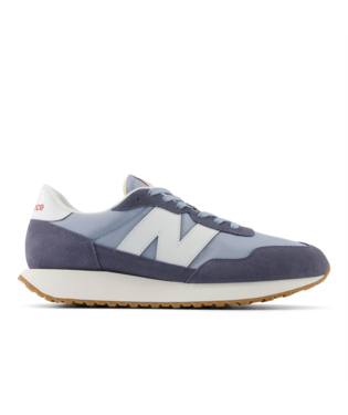 New Balance 237 sneakers in light blue and navy suede with white side logo and gum outsole, side view.