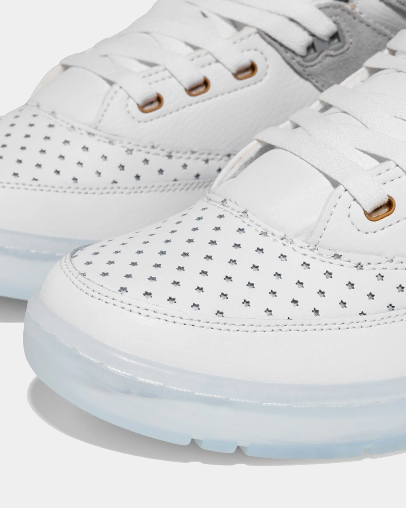 Ewing Athletics 33 HI x LAURENS J sneakers in white with perforated star detailing, clear translucent outsole, and white laces, toe box close-up.