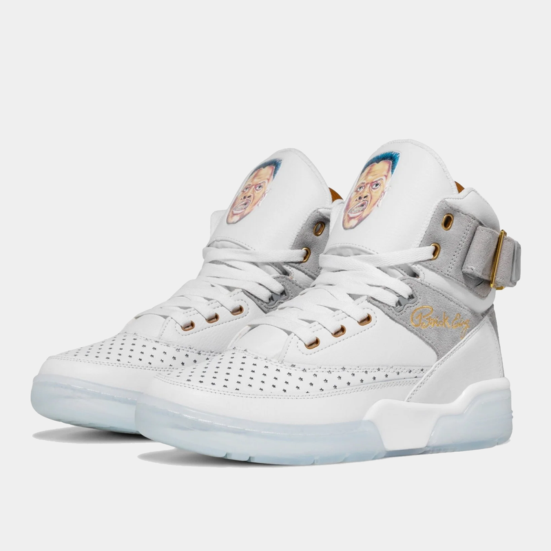 Ewing Athletics 33 HI x Laurens J sneakers in white leather with perforated details, gold accents, graphic tongue design, and translucent outsole, angled front view.