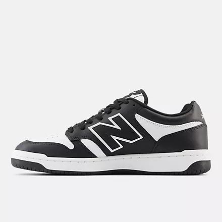New Balance 480 sneakers in black and white leather, side view showing logo and lace-up design.
