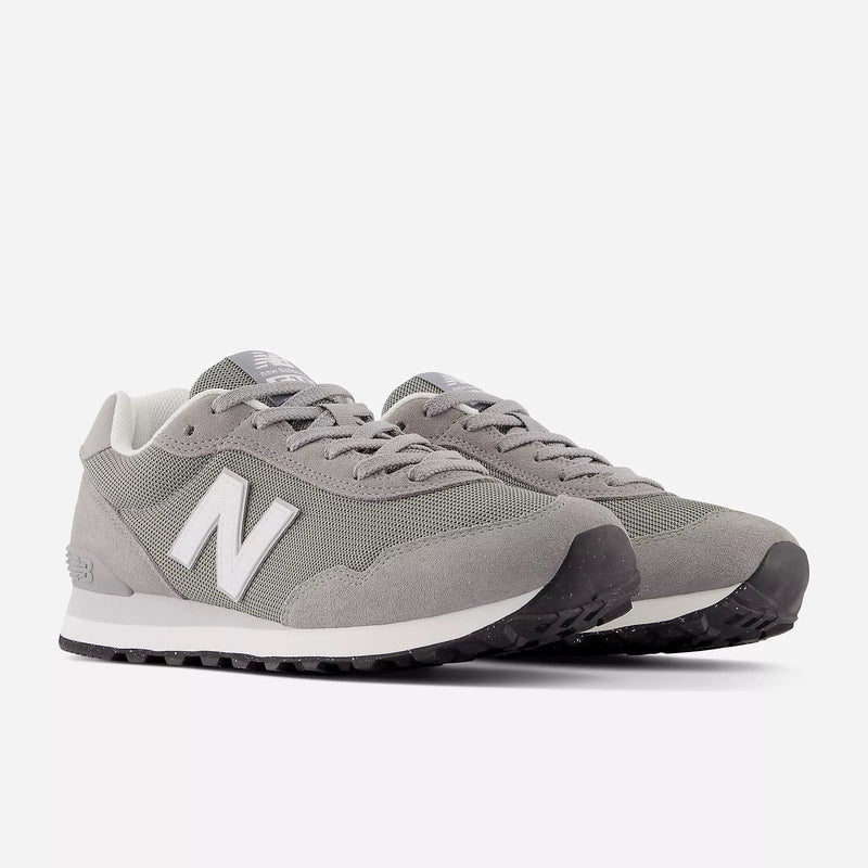 New Balance 515 v3 sneakers in gray with suede and mesh upper, white midsole, and black rubber outsole, angled front view.