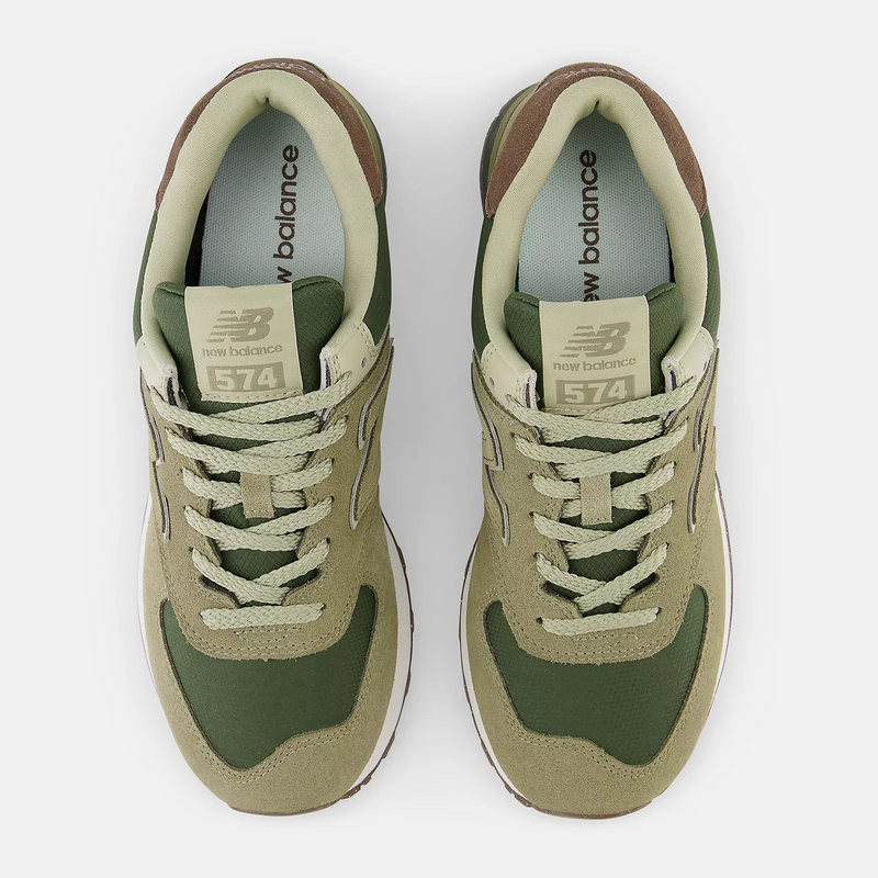 New Balance 574 sneakers in olive green and beige with suede overlays and mesh panels, top view showing lace-up design.
