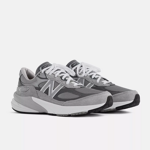 New Balance 990v6 running shoes in gray with suede overlays, mesh panels, and white laces, angled front side view.