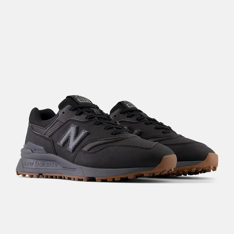 New Balance Golf 997 SL Golf shoes in black with synthetic upper, gum outsole, and spikeless design, front side angle.