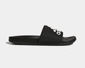 Adidas Adilette Comfort Slides in black with logo-adorned synthetic strap and cushioned footbed, side view.