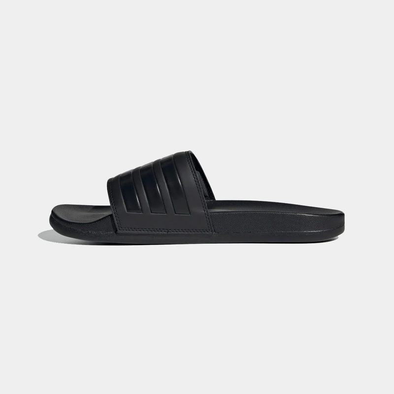 Adidas Adilette Comfort Slides in solid black with synthetic strap and cushioned footbed, side view.