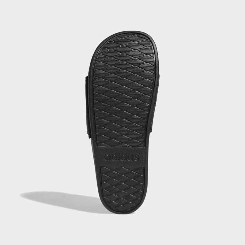 Adidas Adilette Comfort Slides sole view showing textured black rubber outsole with Adidas branding.