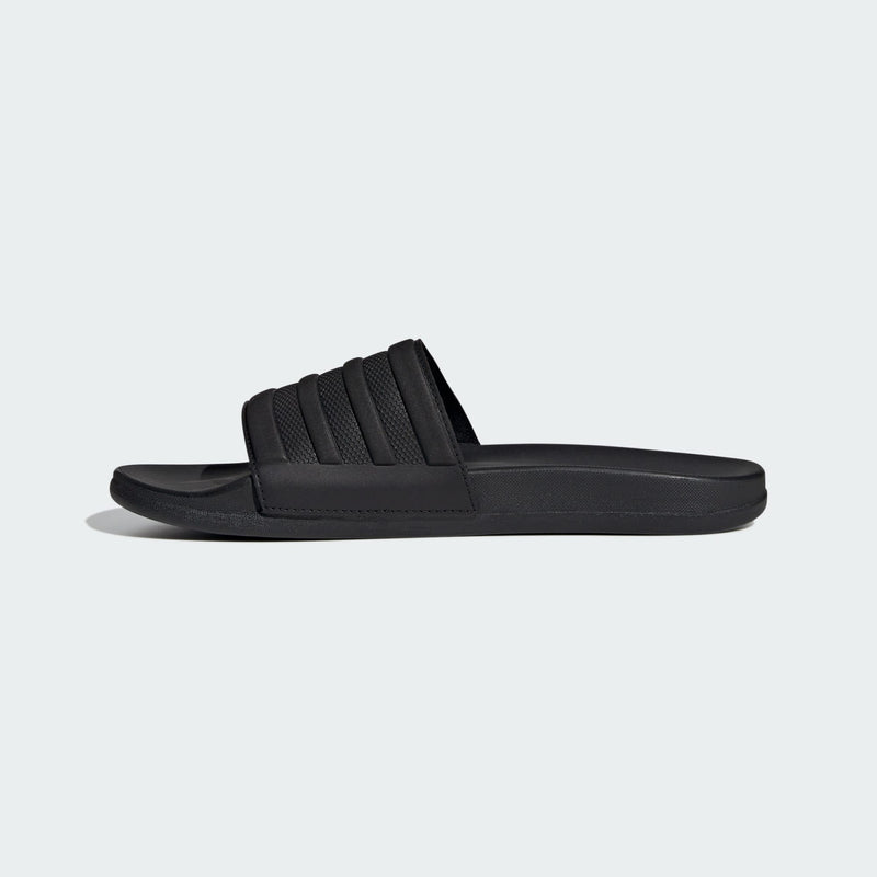 Adidas Adilette Comfort slide sandals in black with textured strap and cushioned sole, side view.