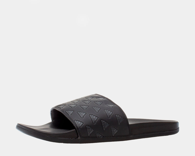 Adidas Adilette Comfort slides in black with embossed Adidas logo design on strap and cushioned footbed, side view.