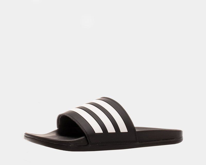 Adidas Adilette Comfort slide sandals in black with white stripe detail and contoured footbed, side angle view