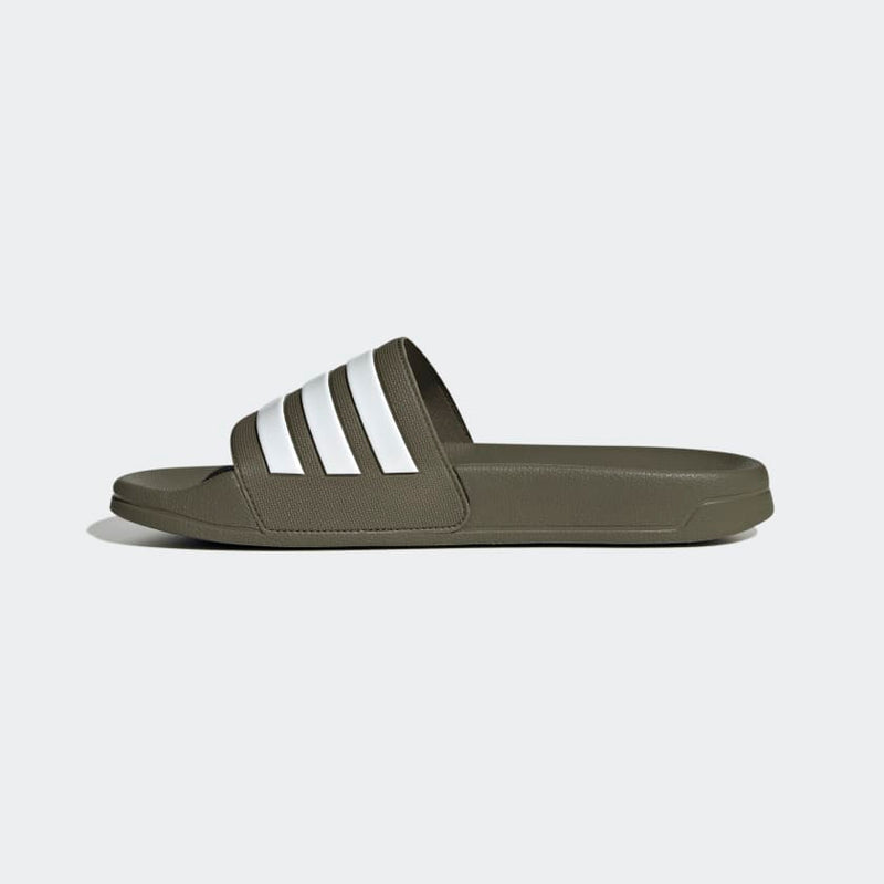 Adidas Adilette Comfort slides in olive green with white striped strap and cushioned footbed, side view.