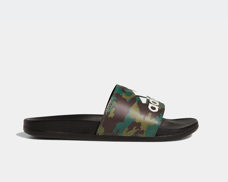 Adidas Adilette Comfort slides with green camo print strap and white logo detailing, side view.