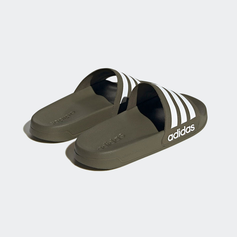 Adidas Adilette Comfort slides in olive green with white stripe accents and embossed branding, angled back view.