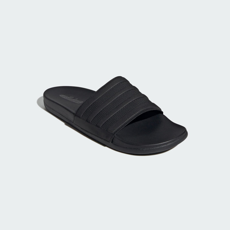 Adidas Adilette Comfort slide sandals in black with textured strap design and cushioned footbed, angled front view.