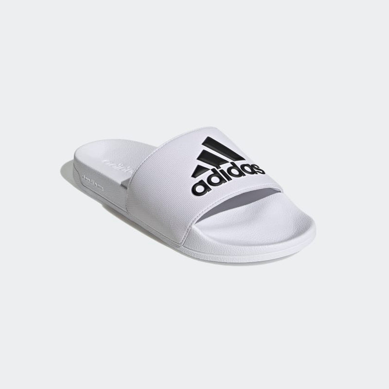 Adidas Adilette Shower Slides in white with black logo design, featuring a lightweight synthetic strap and contoured footbed, angled front view.