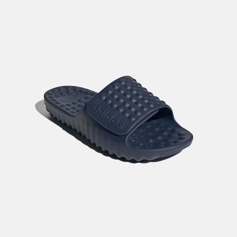 Adidas Adissage 360REC slides in dark navy blue, featuring textured massage footbed and embossed strap logo, side angle view.