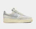 Nike Air Force 1 '07 LV8 sneakers in light gray suede and tonal canvas with signature Swoosh logo, side view.