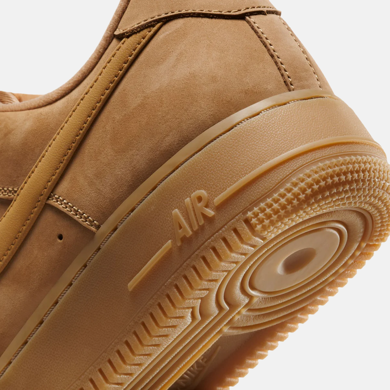 Close-up of a brown sneaker with 'Air' branding on the sole.