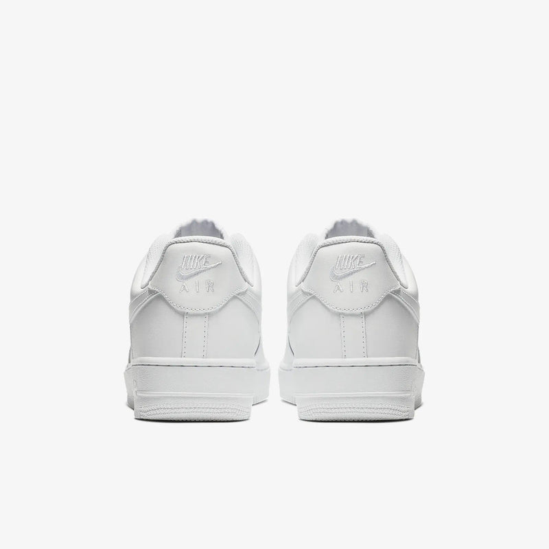 Nike Air Force 1 '07 sneakers in white leather with embossed Nike Air logo and padded heel counter, back view.