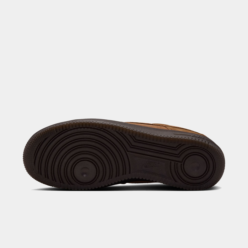 Nike Air Force 1 '07 sneakers outsole in dark brown with circular tread pattern and embossed Nike logo, bottom view.