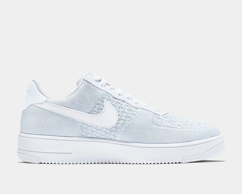 Nike Air Force 1 Flyknit 2.0 sneakers in white with textured Flyknit upper, white swoosh logo, and foam midsole, side view.