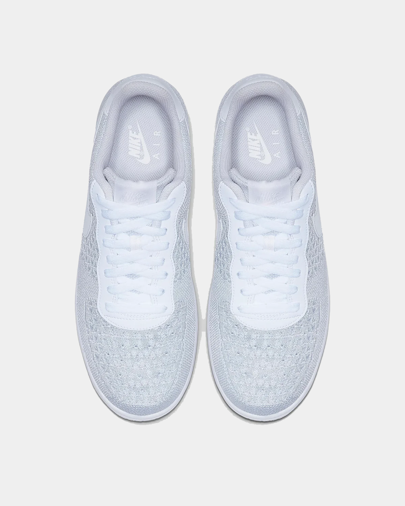 Nike Air Force 1 Flyknit 2.0 sneakers in white with lightweight Flyknit upper, top view showing lace design and branded insoles.
