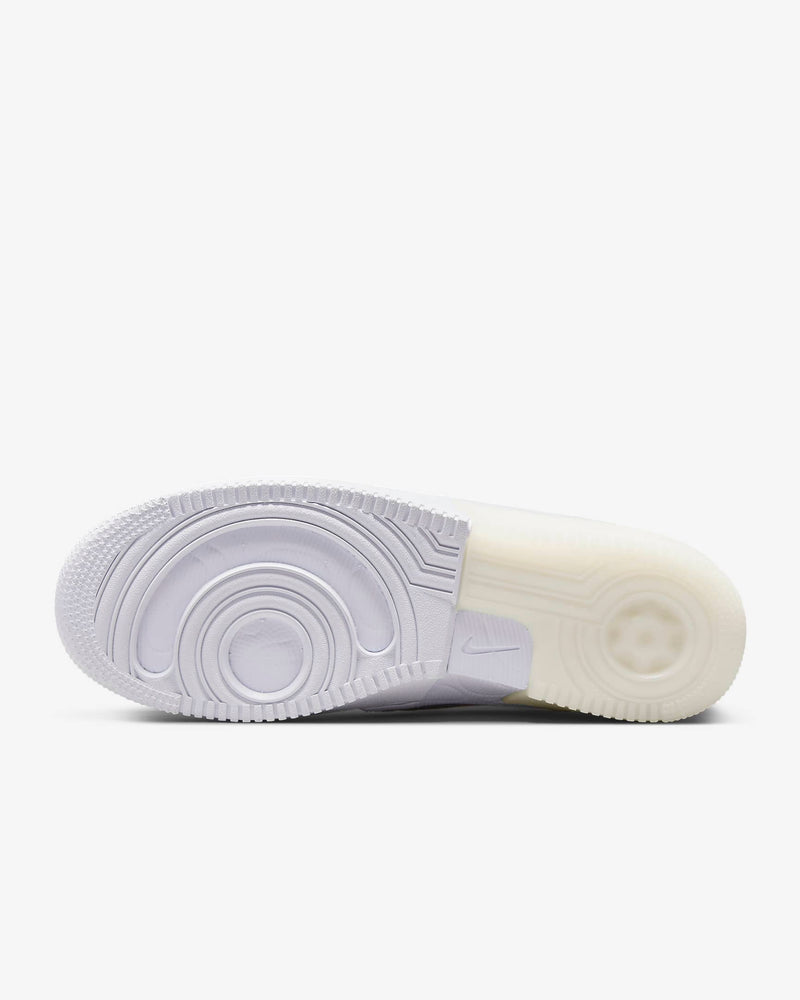 Nike Air Force 1 React sneaker outsole in translucent white showing React foam technology and circular tread pattern.