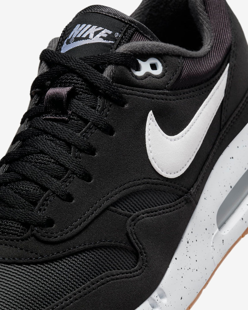 Nike Air Max 1 '86 OG Golf shoes in black with white leather Swoosh, mesh accents, and speckled midsole, close-up angled view.