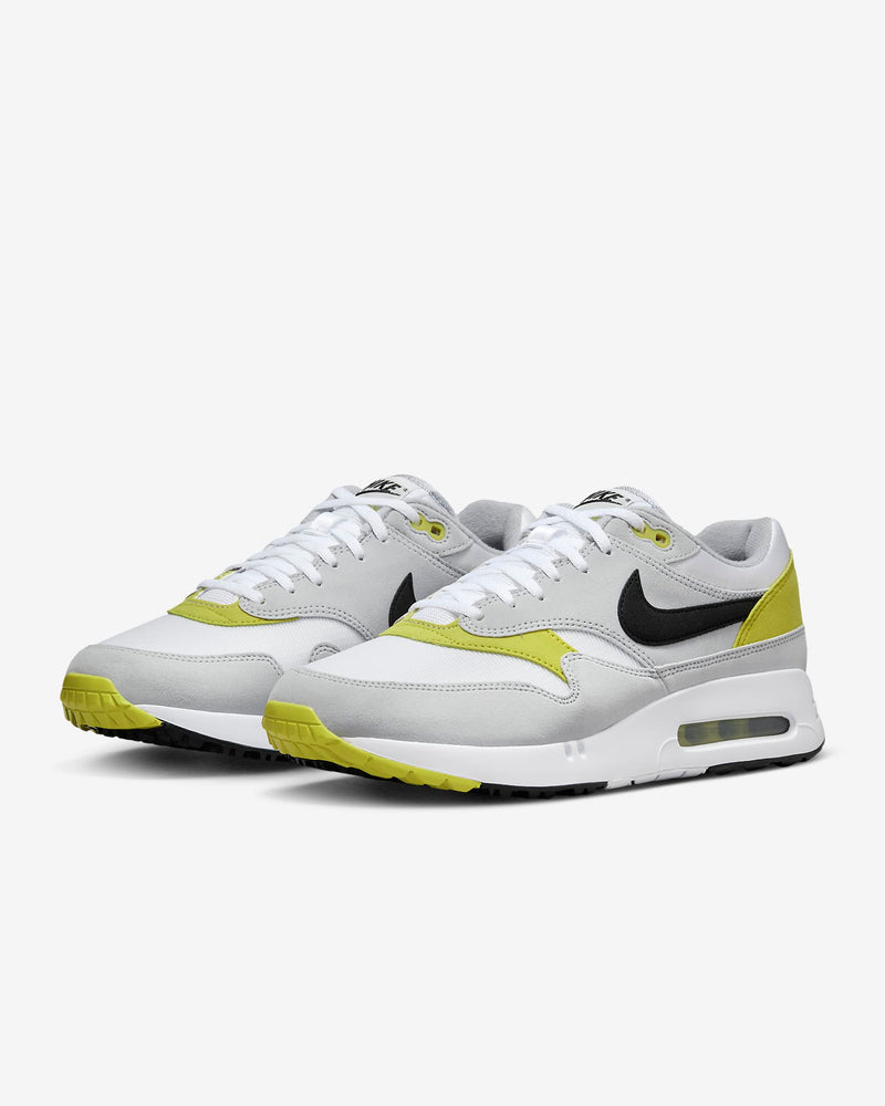 Nike Air Max 1 '86 OG Golf shoes in white, gray, and yellow with black Swoosh and visible Air cushioning, front angle view.