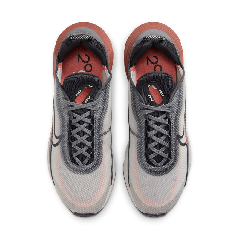 Nike Air Max 2090 sneakers featuring a mesh upper in gray with black laces, translucent overlays, and orange accents, top view.