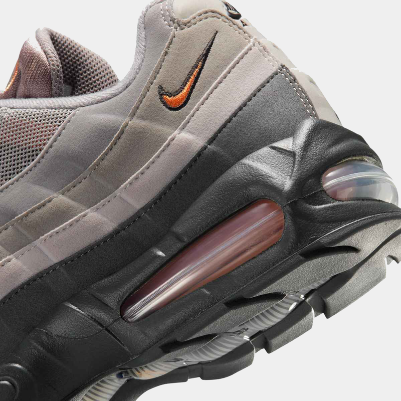 Nike Air Max 95 Big Bubble "OG" sneakers with gradient gray upper and orange Swoosh, side view illustrating the air cushioning.