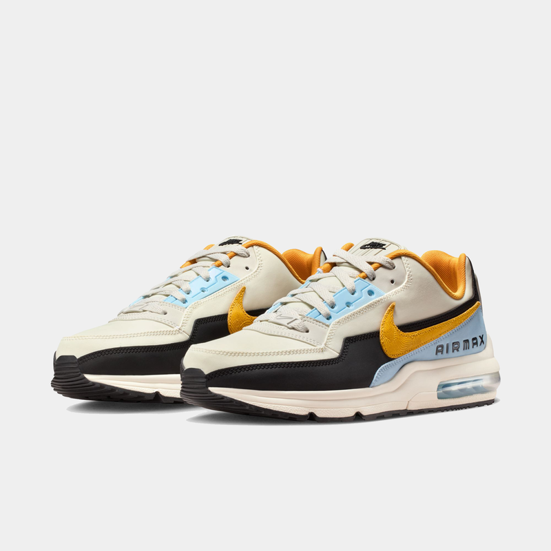 Pair of Nike Air Max sneakers with a white, yellow, and black color scheme on a white background.