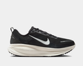Nike Air Zoom Vomero 18 running shoes in black with white midsole and Nike Swoosh, side view showing ZoomX cushioning.