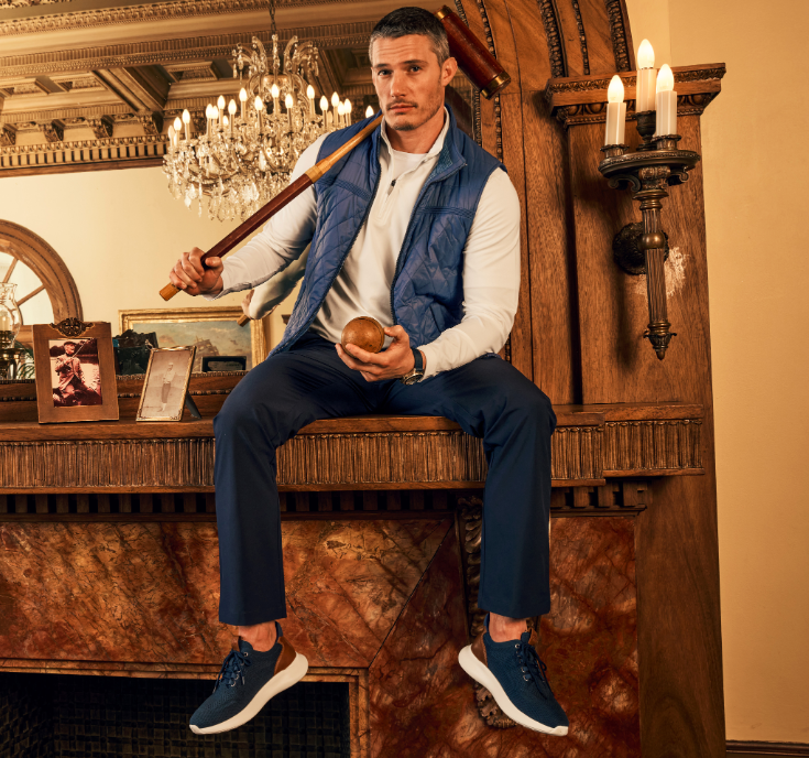Johnston & Murphy Amherst 2.0 Knit Plain Toe sneakers in navy blue with knit upper and white soles, worn in a casual lifestyle setting.