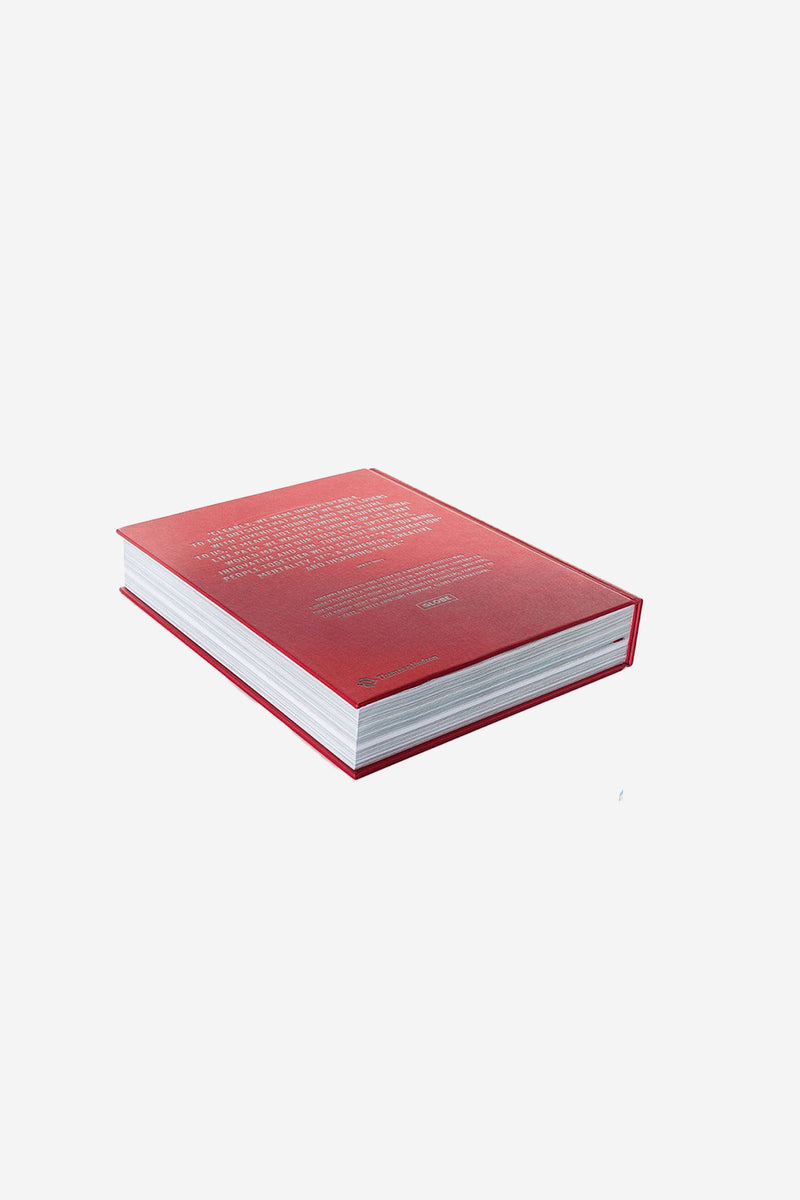 Red hardcover Unemployable Version 2 anniversary book lying flat against a white background