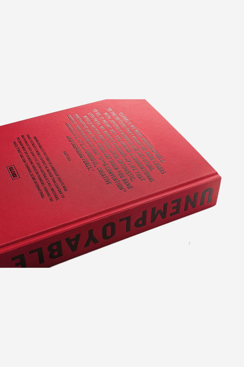 Angled view of red Unemployable book with bold title along the spine