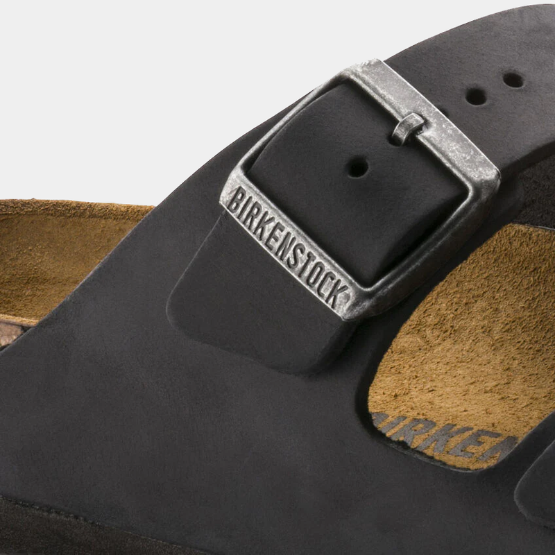 Birkenstock Arizona Oiled Leather sandals close-up showing black oiled leather strap and silver adjustable buckle.