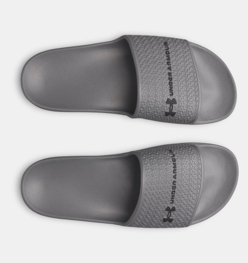Under Armour ARMR Shower slides in gray featuring textured strap and logo, top view.