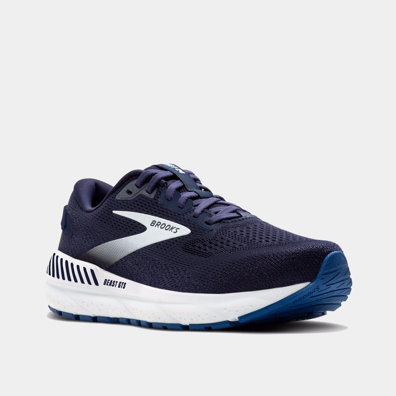 Navy running shoe with white sole on a light gray background
