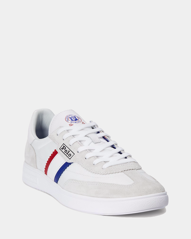 Polo Ralph Lauren Bedford Suede-Paneled Sneaker in white with gray suede accents, red and blue side stripe detailing, and lace-up closure, front angle view.