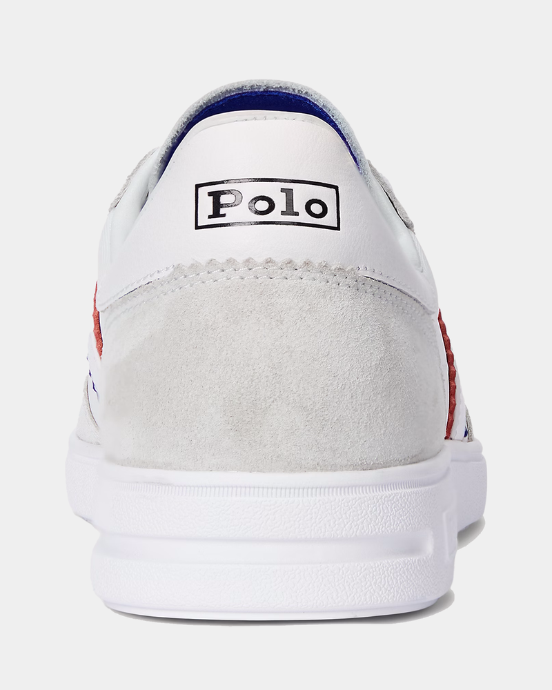 Polo Ralph Lauren Bedford Suede-Paneled Sneaker back view showing white leather upper, gray suede panel, and Polo logo detailing.