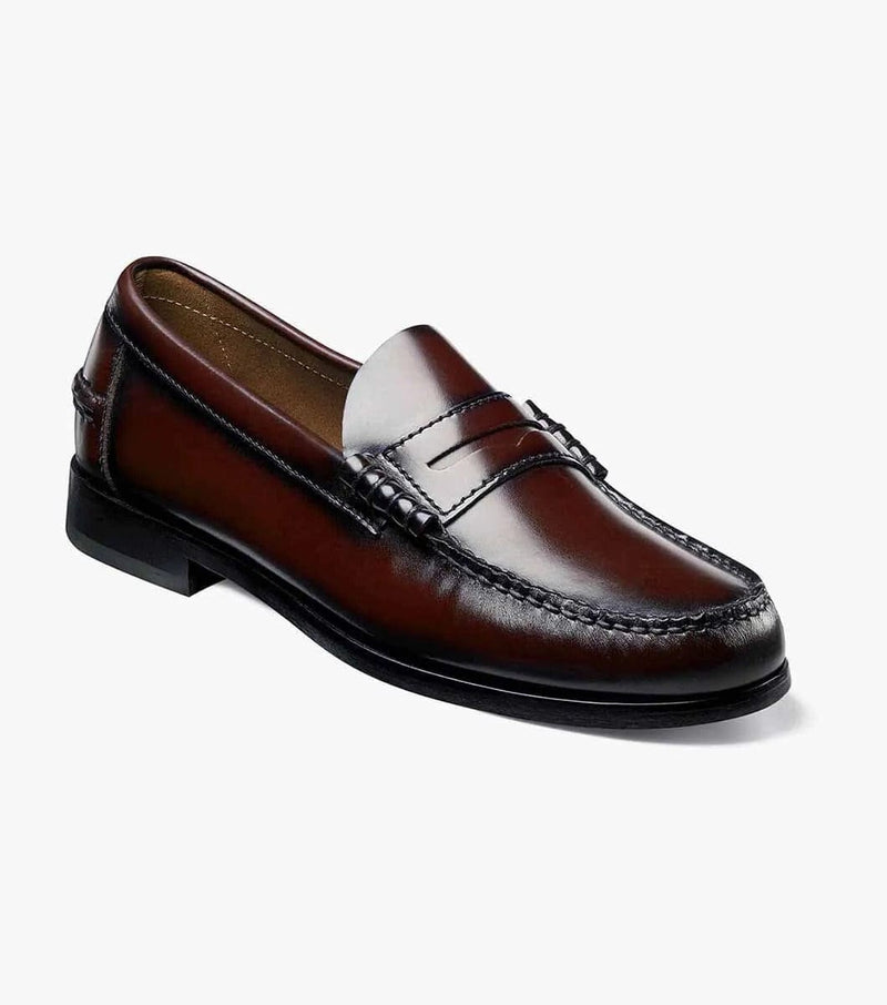 Florsheim Berkley Penny Loafer in Burgundy leather with moccasin-style stitching and penny slot detail, angled side view.