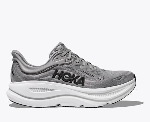 HOKA Bondi 9 running shoes in gray with a breathable mesh upper, thick white cushioning midsole, and black logo detailing, side view.