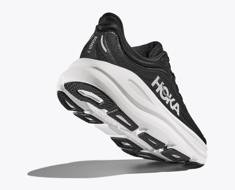 HOKA Bondi 9 running shoes in black with white midsole and outsole featuring cushioning and traction details, angled heel-bottom view.