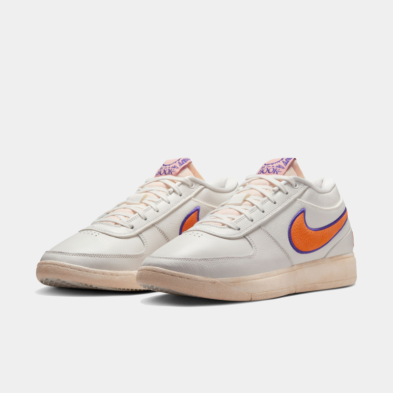 Nike Book 1 Decade sneakers in white leather with orange and purple accents featuring a stitched Swoosh logo, front-side view.