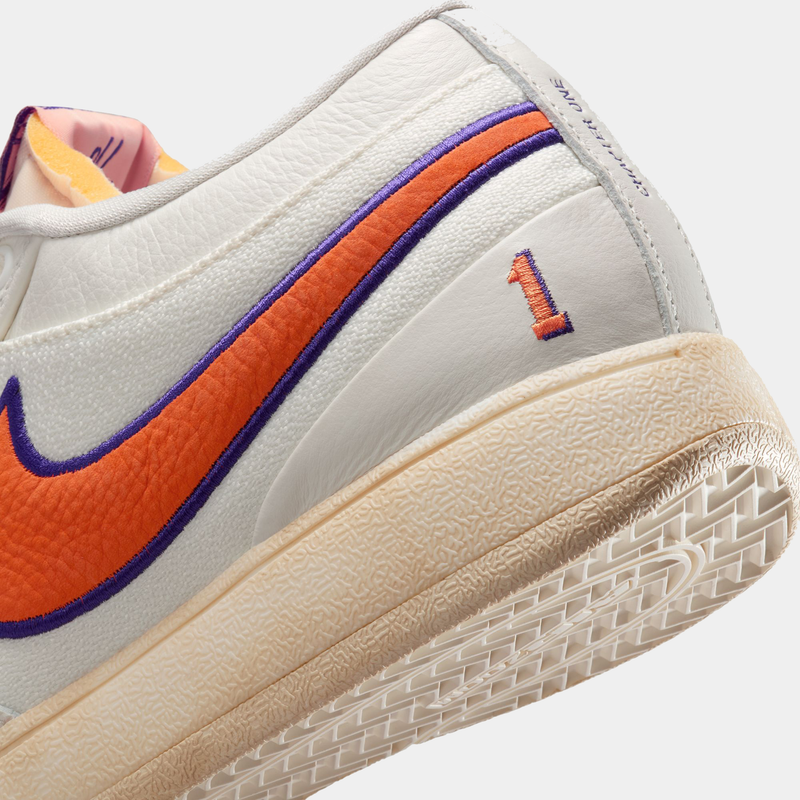 Nike Book 1 Decade shoes featuring a white leather upper with an orange and purple Swoosh, embroidered "1" detail, and textured cream midsole, side angle close-up.