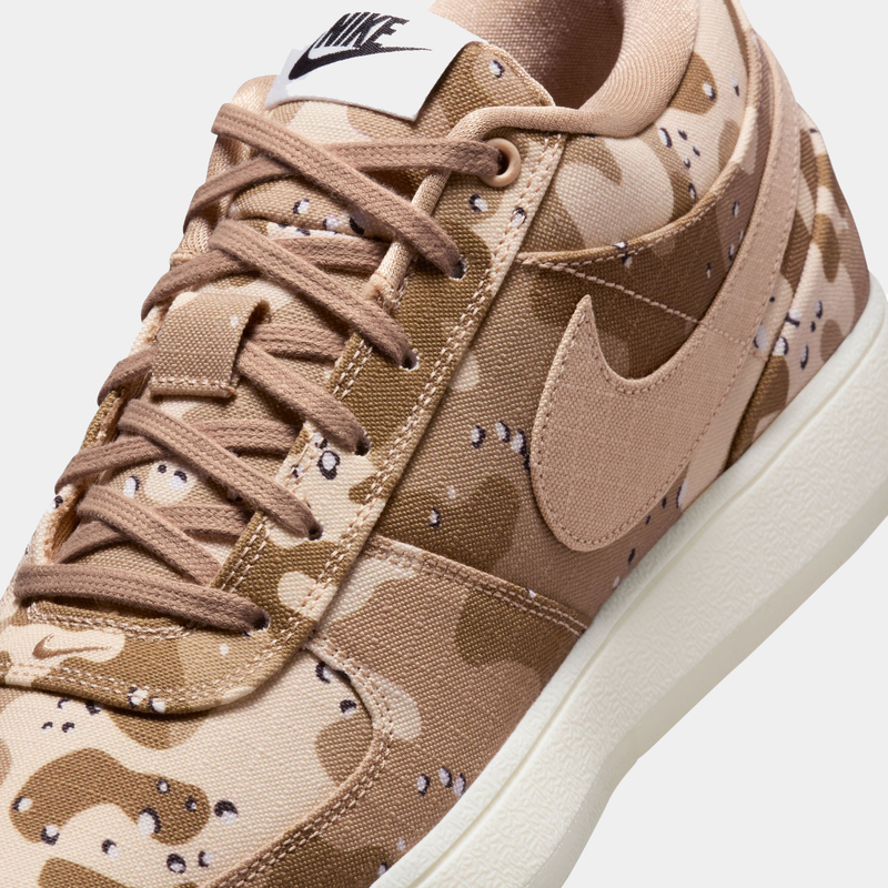 Nike Book 1 SE sneakers featuring a tan and beige camouflage canvas upper, tonal laces, and a white rubber sole, close-up front and side view.