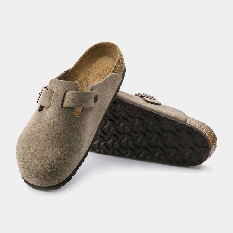 Birkenstock Boston Soft Footbed clogs in taupe suede with adjustable buckle straps and cork soles, angled view showing textured outsole.