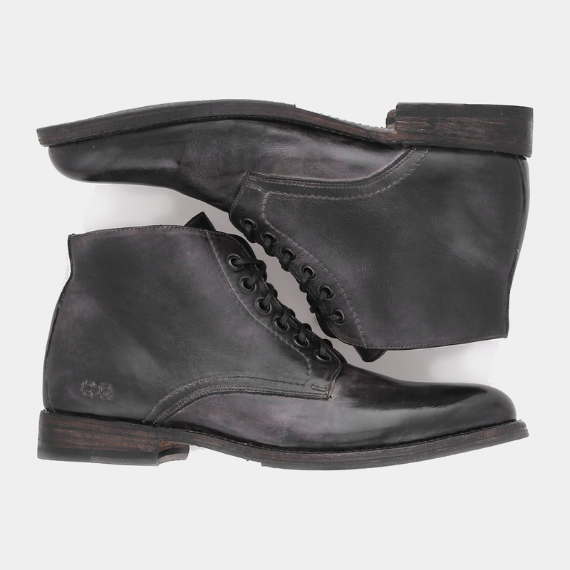 Bed Stu Bradley boots in distressed black leather with lace-up design and stacked wooden heel, side view.